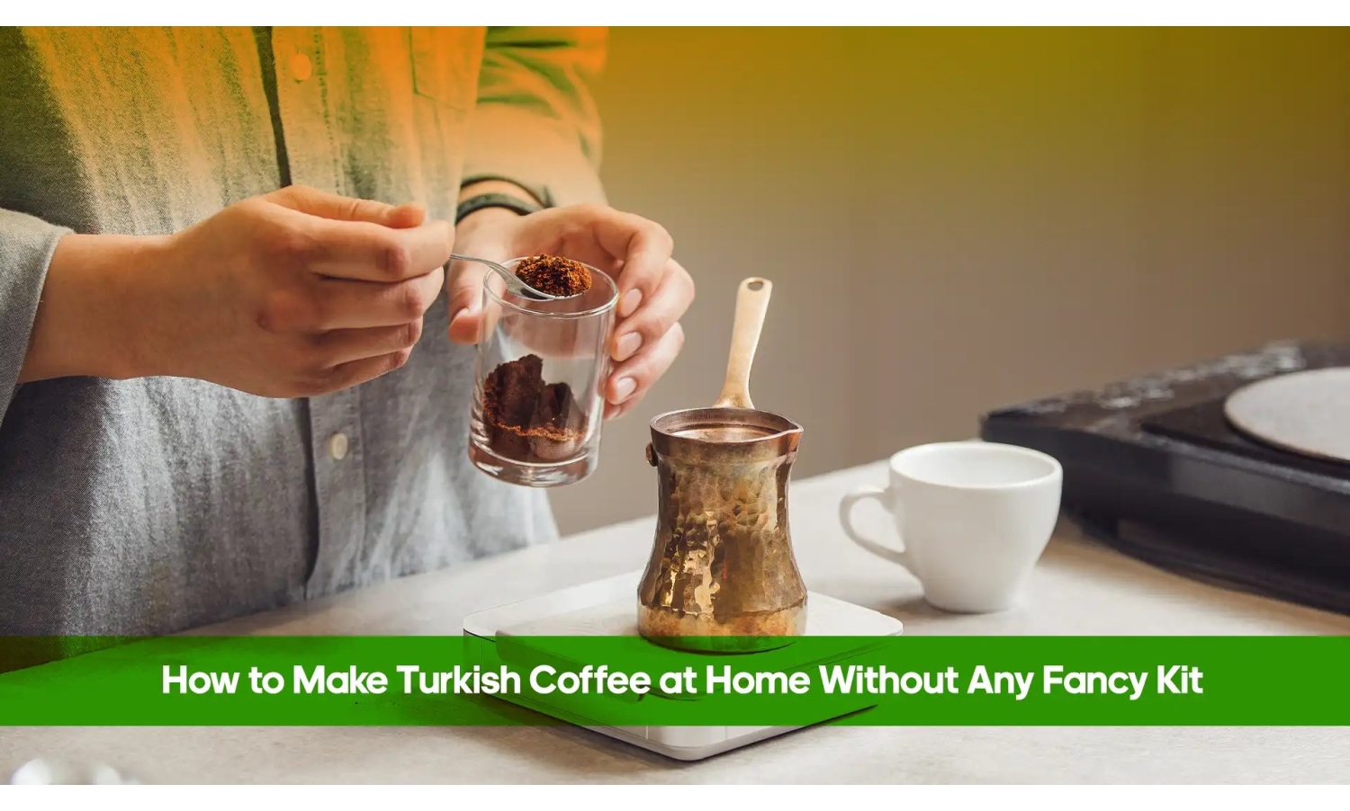 Hands spooning ground Turkish coffee into a copper cezve beside a white cup